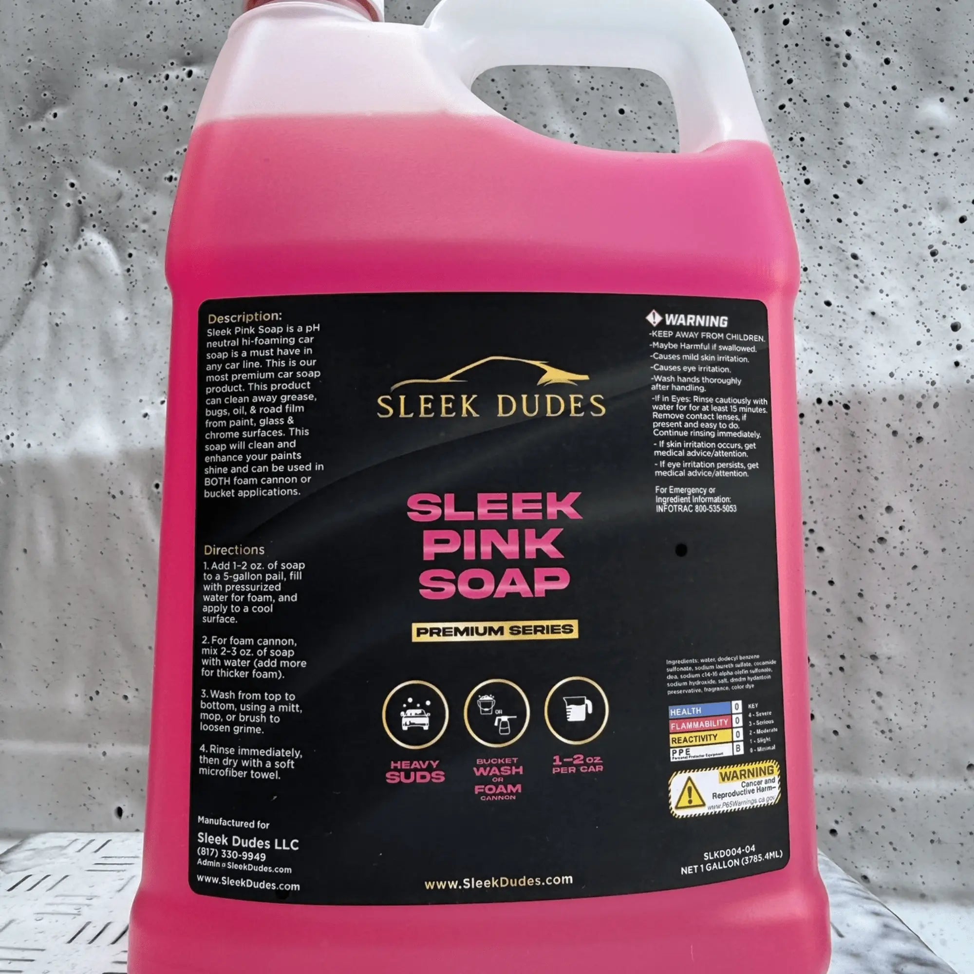 Pink bottle of 'Sleek Pink Soap' with a black label on a gray background