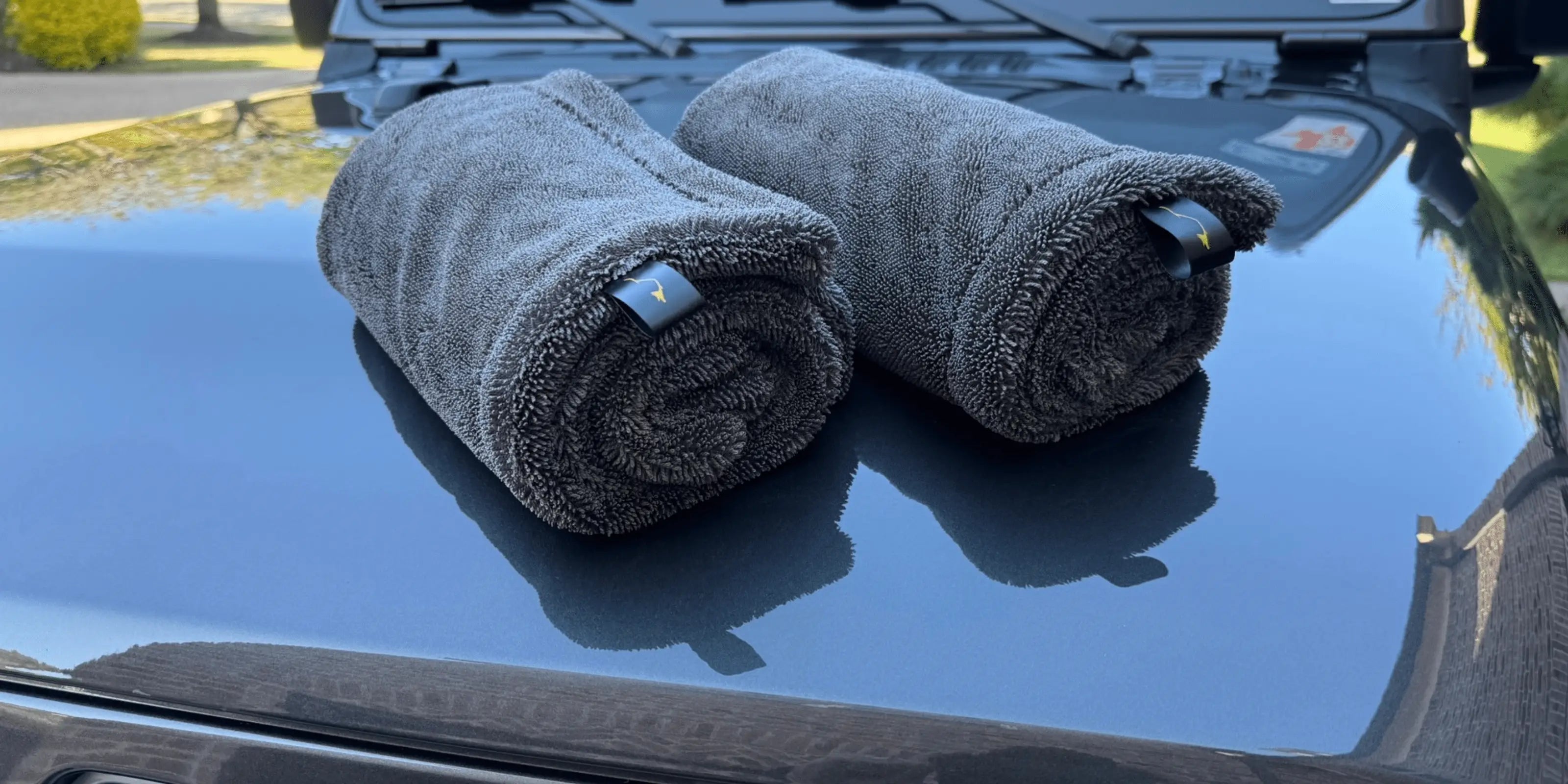 Two rolled-up towels on a car hood