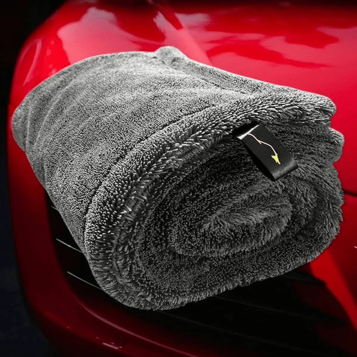 Sleek Max Dry 2K Towel with a red car on the background