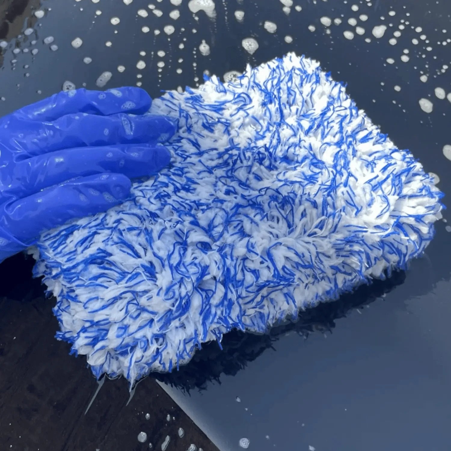 Non-latex nitrile glove in use while washing a car with a microfiber wash pad