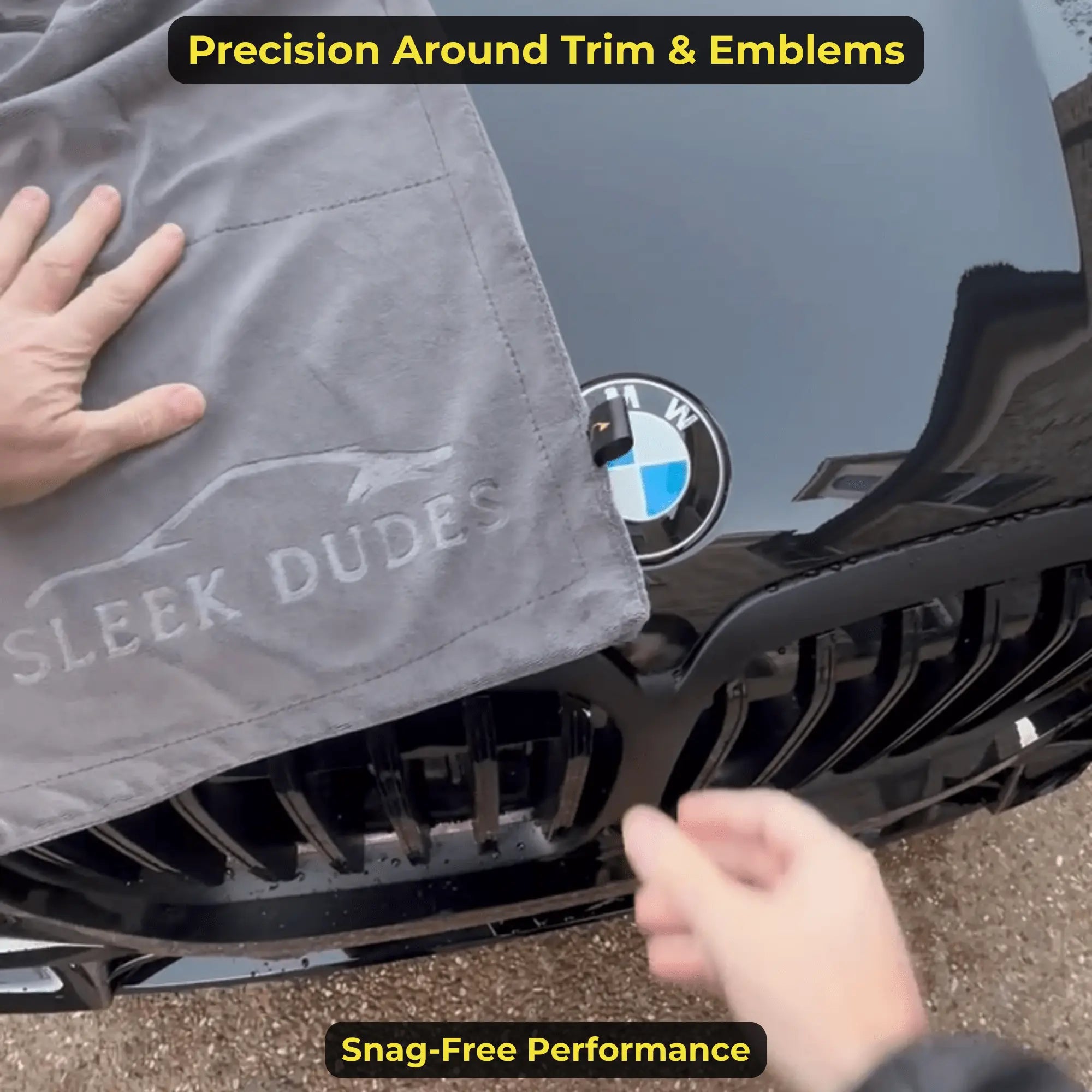 Microfiber towel drying around car trim and emblems