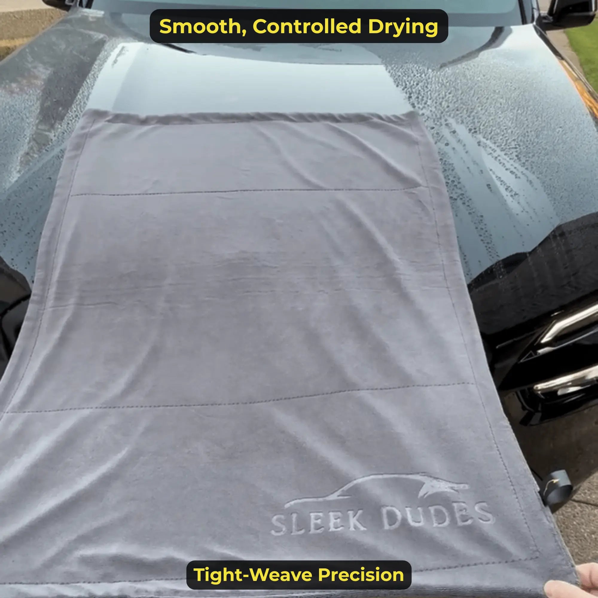 Gray towel with 'Sleek Dudes' branding draped over a car, with text about drying and precision.