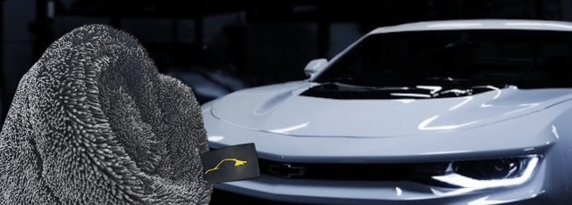 Sleek Dudes Drying Towel on a front of a white car