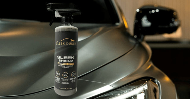 leek Shield Graphene & Ceramic Spray Coating bottle placed on a clean, glossy black car hood