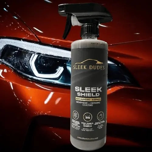 Sleek Dudes Sleek Shield ceramic coating bottle in front of a red car.