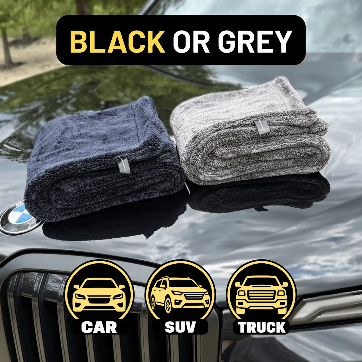 Two folded microfiber one black and one grey, displayed on a car hood with a 'BLACK OR GREY' text banner at the top and vehicle type icons at the bottom.