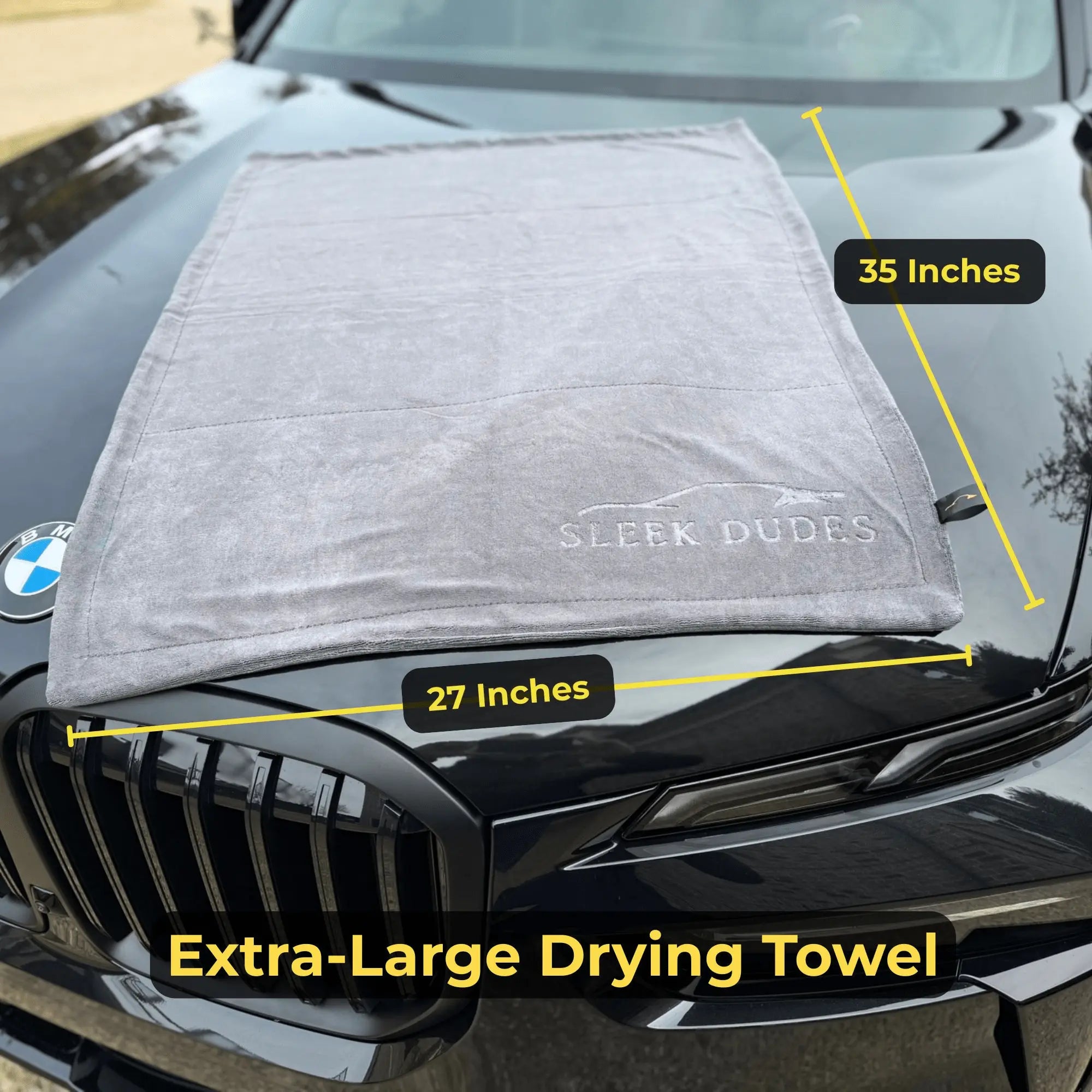 Extra-large drying towel on a car hood with measurements and brand name displayed.