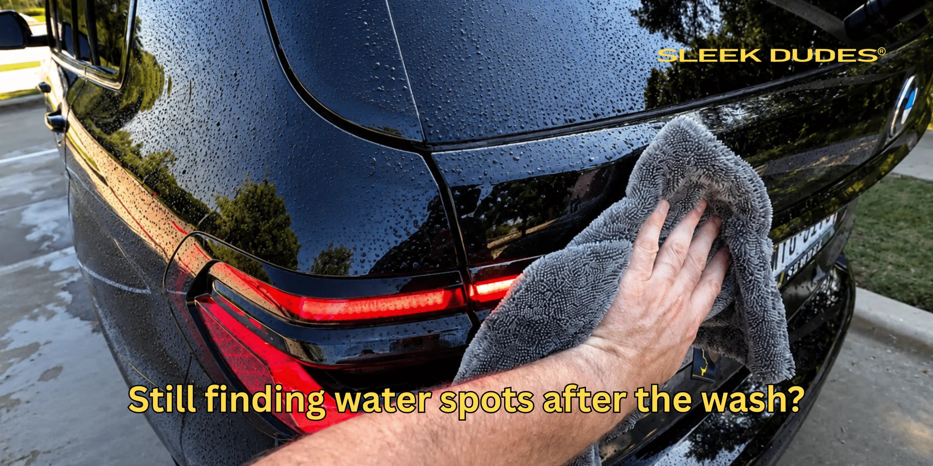 Person cleaning a car with a towel, with 'Sleek Dudes' branding visible.