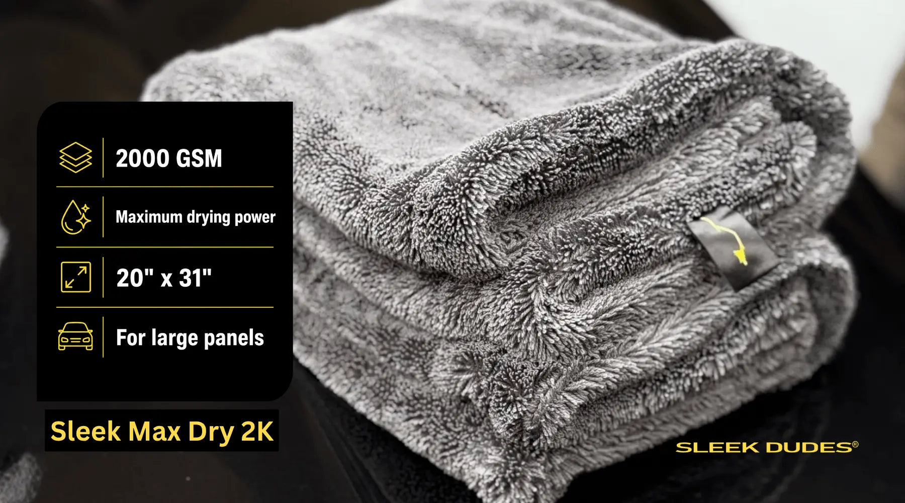 Gray towel with product details on a black background