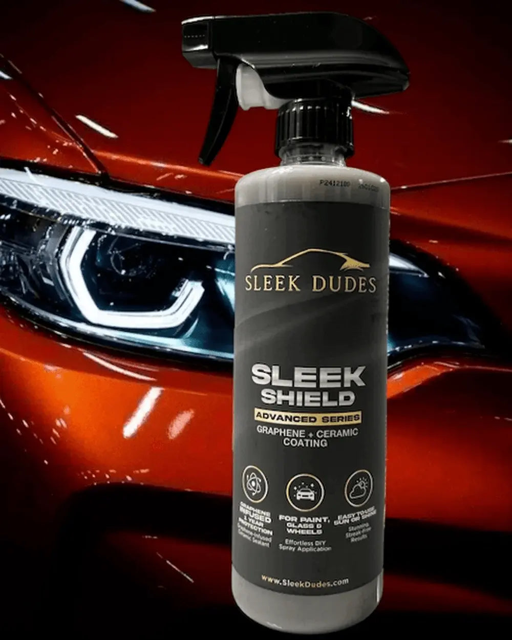 Sleek Dudes Sleek Shield car care product bottle in front of a red car.