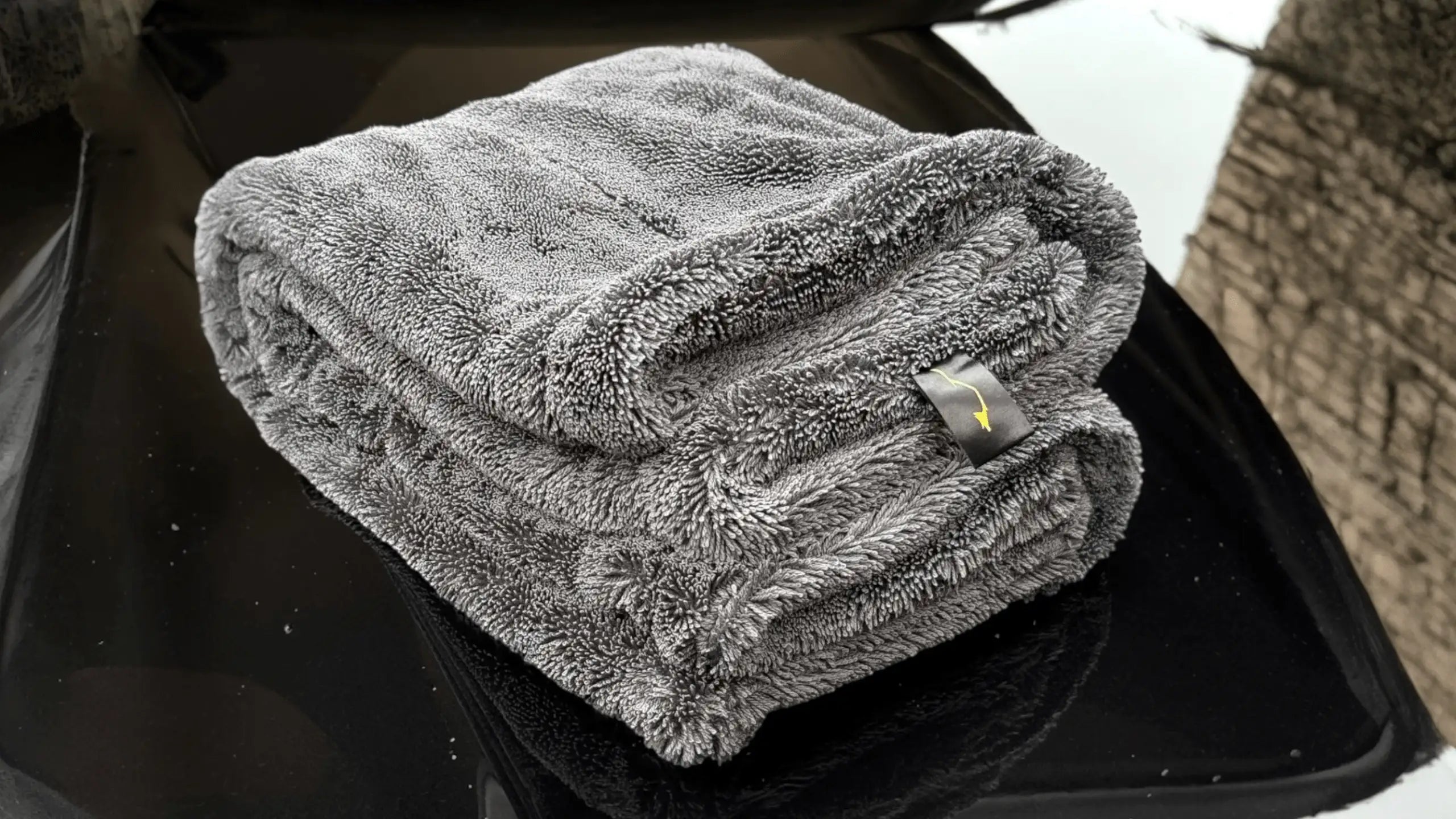 Sleek Dudes Sleek Max Dry 2K – 2000GSM microfiber drying car towel on a car hood.